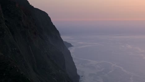 sunset cliff seascape, drone establishing shot