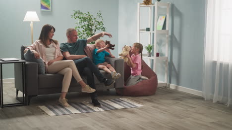 mom and dad play toys together with children, express joy, laugh