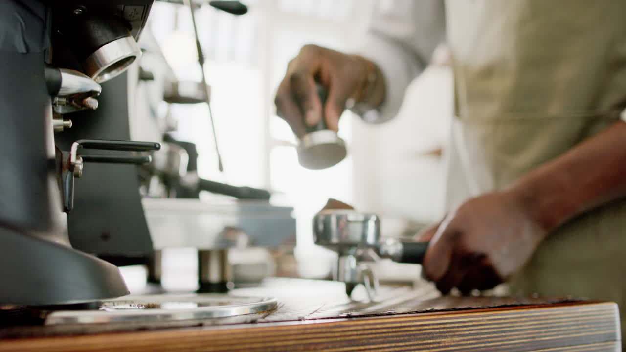 Barista afroamericano sta preparando caffè macinato con una macchina da caffè espresso