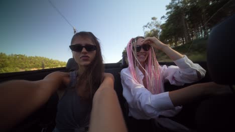 two women enjoying a convertible road trip