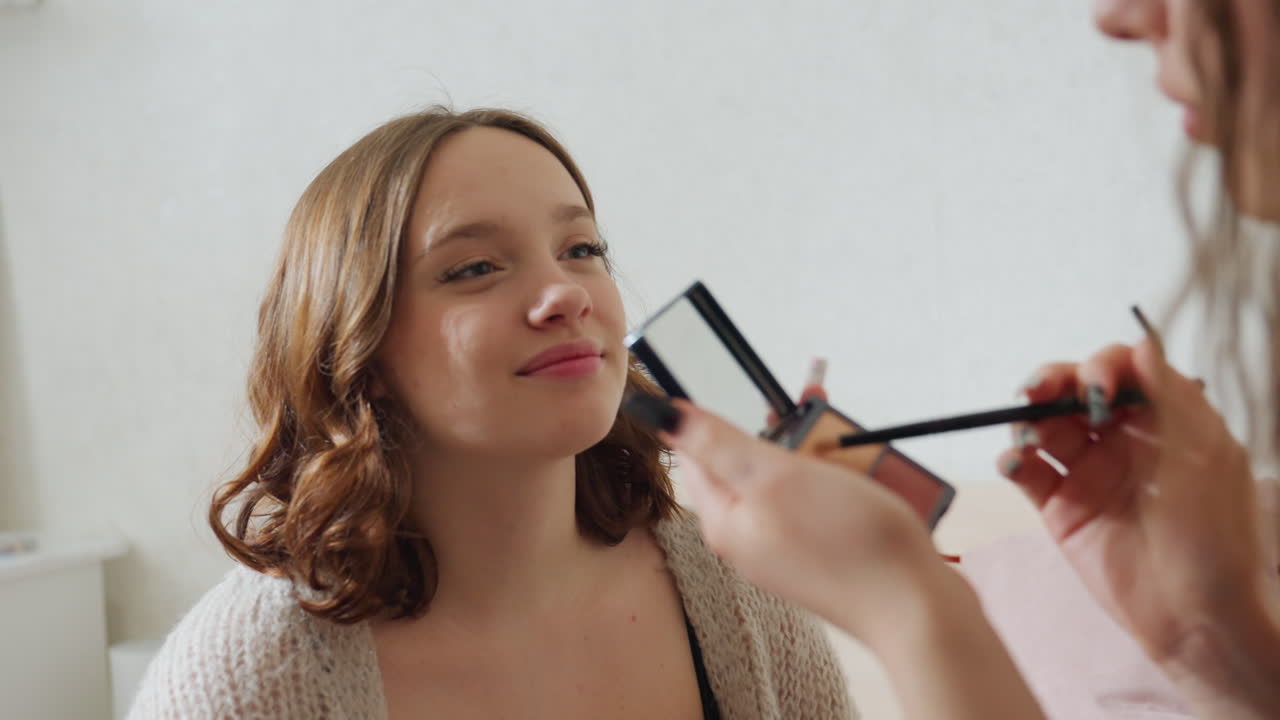 Smiling Woman Appreciates Creative Portrait, Warm Natural Light Highlights Friendly Art Scene Interaction, Pleasant Woman Reacts Happily As Artist Paints Her Using Vibrant Colors And Gentle Light