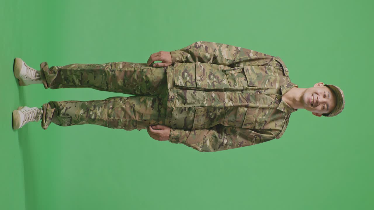 Full Body Of Asian Man Soldier Standing And Smiling To Camera In The Green Screen Background Studio