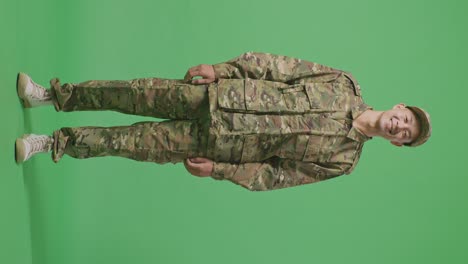 full body of asian man soldier standing and smiling to camera in the green screen background studio