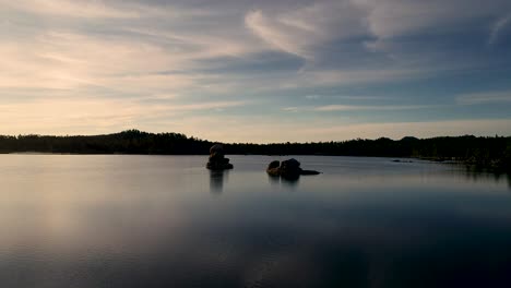 This-aerial-lake-clip-bathes-the-viewer-in-gold,-teal,-orange,-and-deep-blue-reflections-as-this-Colorado-sunrise-stuns