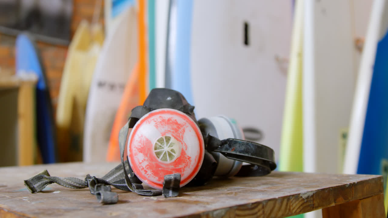 Gas mask and surfboards in workshop 4k