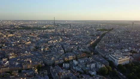Aerial-panoramic-footage-of-town-development-in-large-city-at-dusk.-Eiffel-Tower-and-modern-business-borough-in-distance.-Paris,-France