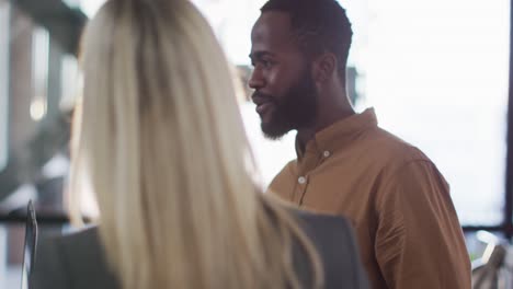 African-american-businessman-discussing-together-with-colleagues-and-standing-around