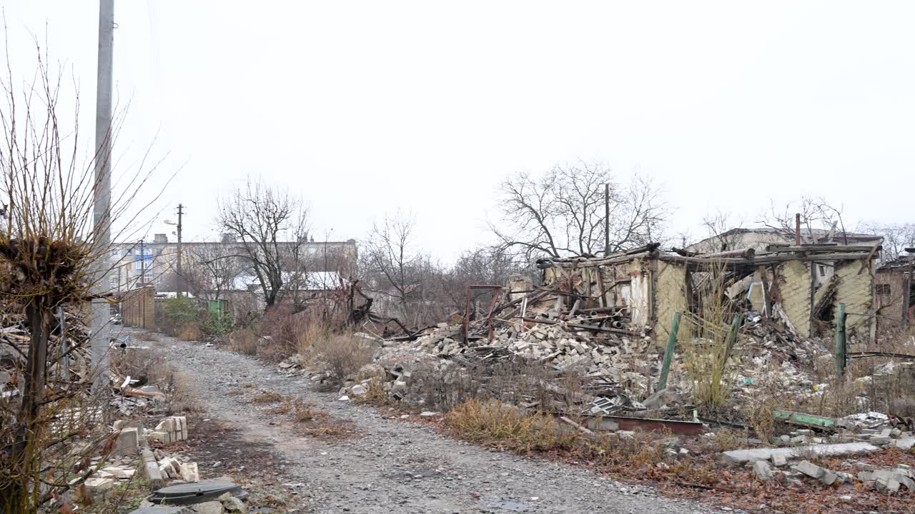 A panning shot documents the widespread destruction of a residential area in Kupiansk, Ukraine. The ruins of numerous homes serve as stark evidence of heavy Russian shelling on the frontline city