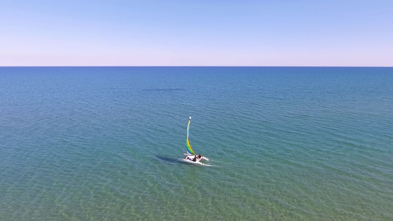 Drone shot of Catamaran sailing in the waters of MAkenzy beach Cyprus