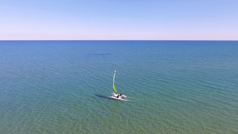 drone shot of catamaran sailing in the waters of makenzy beach cyprus