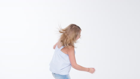 Girl-Jumping-And-Posing-Against-White-Studio-Background