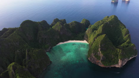 Aerial-view-of-iconic-tropical-turquoise-water-Maya-Bay-surrounded-by-limestone-cliffs,-Phi-Phi-islands,-Thailand