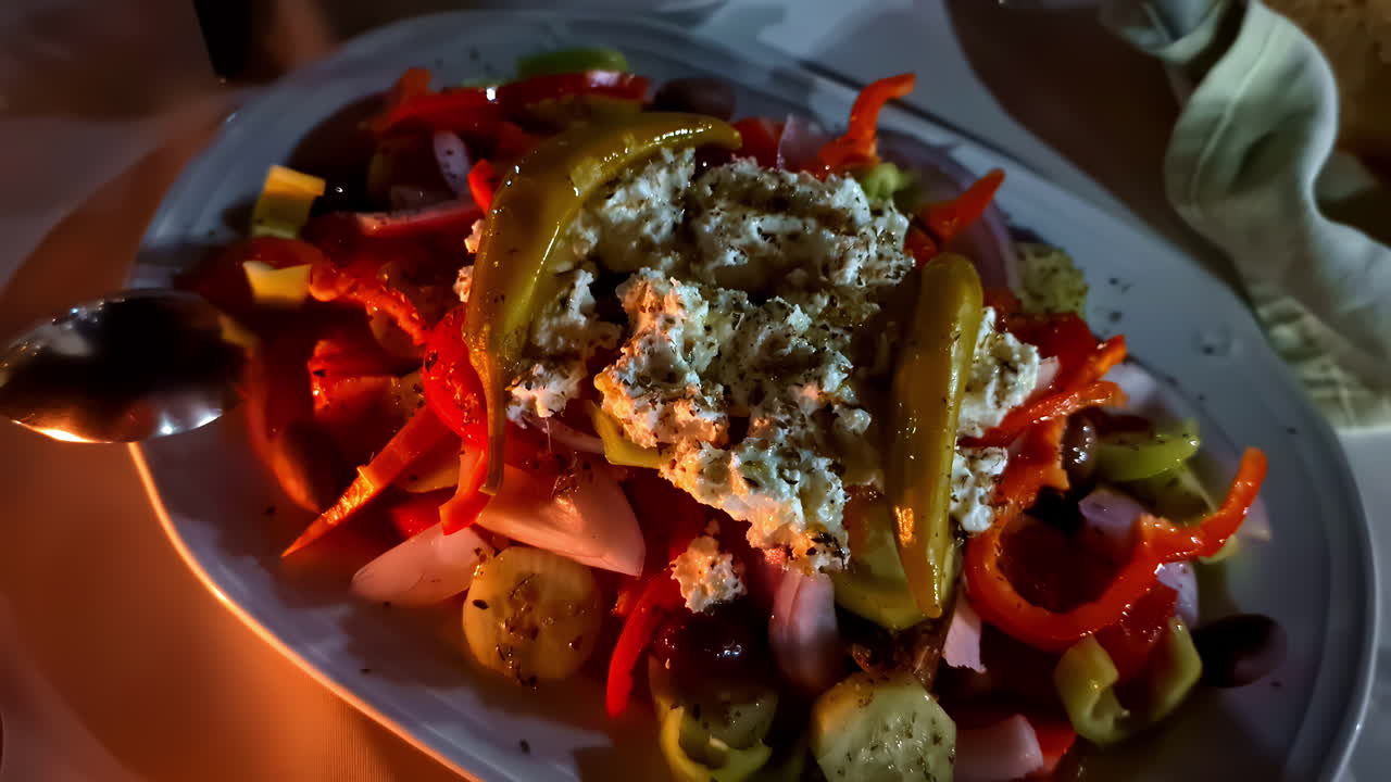 Authentic Greek Salad (Horiatiki) Served Over Dinner Table. Zoom Out Shot