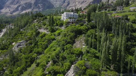aerial view of small hotel building in landscape of hunza valley pakistan, drone shot