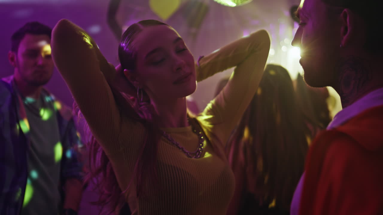 Trendy girlfriend dancing boyfriend in night party closeup. Romantic couple club