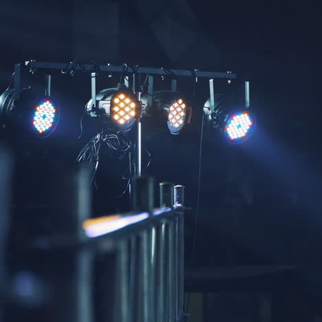 bright lights from the projector shining from the scene on the blurred background. projector lens lightning at disco on a special stand intdoors.