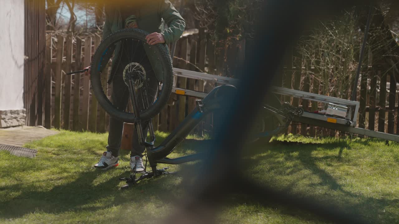 Man repairing his mountain bike in the garden