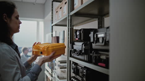 scientist organizing equipment in a lab storage room