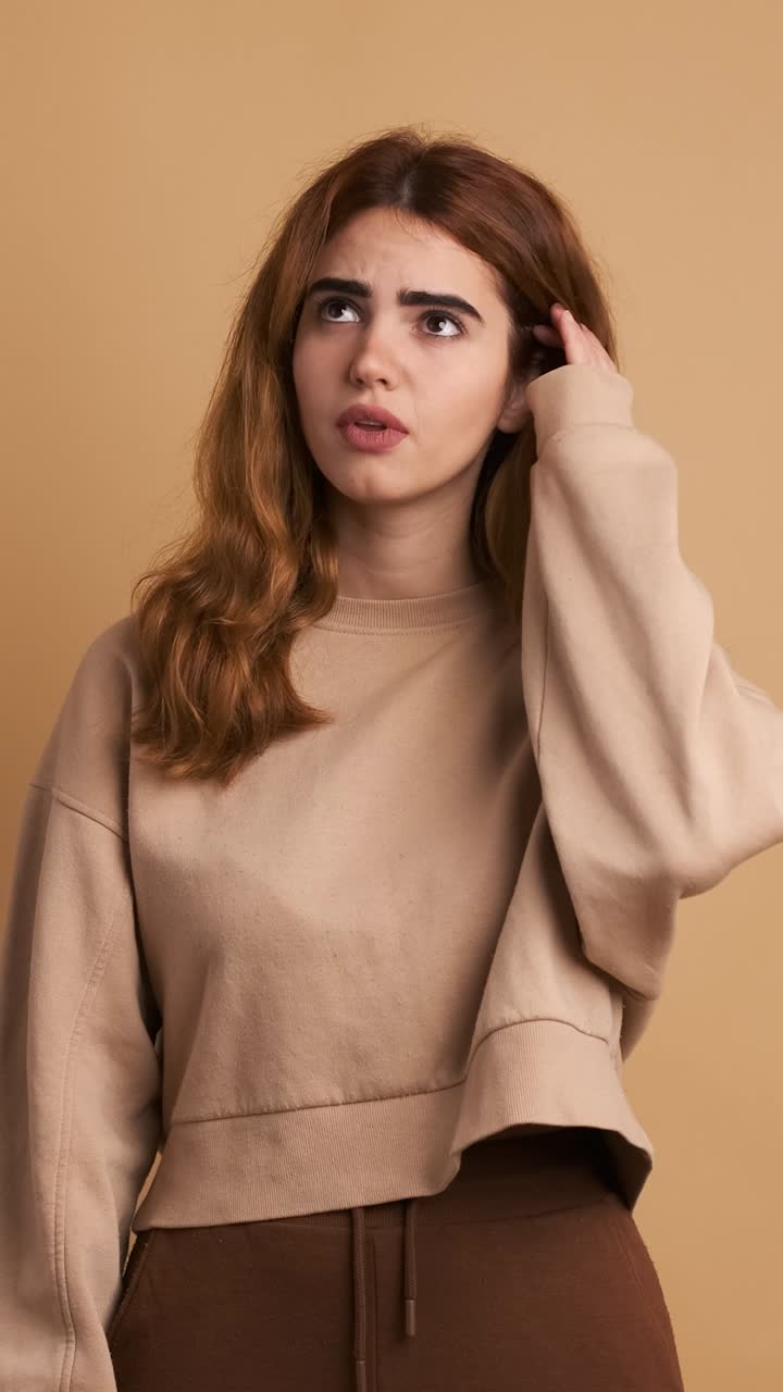 Worried woman gesturing and looking at camera.Vertical Footage