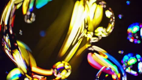 colorful soap bubble swirling and creating an hypnotic abstract pattern with bokeh effect on dark background, perfect for backgrounds and creative projects