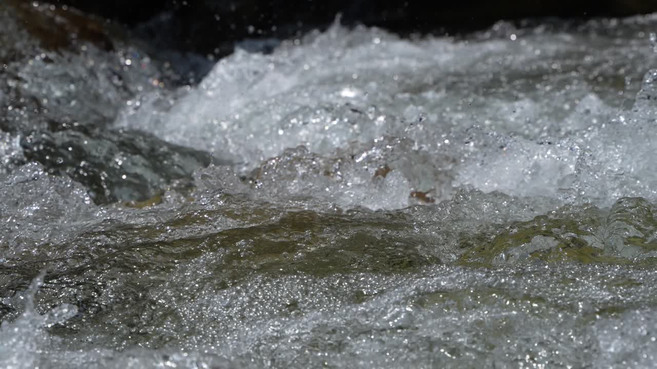 Water is flowing through a mountain torrential river.