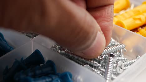 assorted hardware and fasteners in storage box