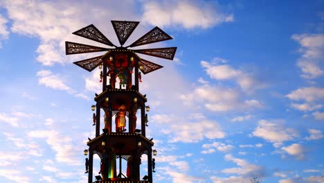 Wooden-German-decorated-spinning-windmill-outside-winter-Christmas-market-on-sunset-evening