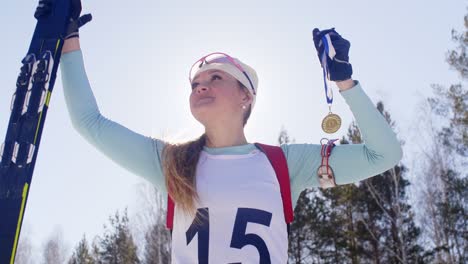 smiling sportswoman celebrating victory in biathlon race