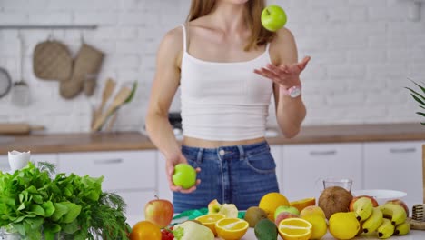 woman kitchen portrait with fruits. attractive athletic sportive woman standing in kitchen