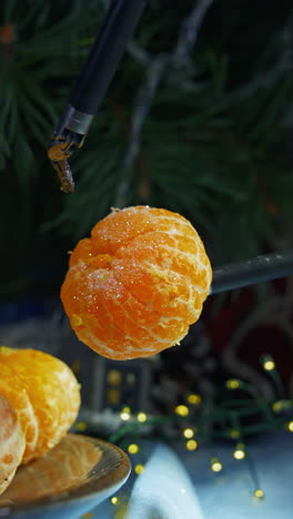 robotic equipment for peeling tangerines. fresh mandarin on plate for new year celebration. modern technology for christmas. vertical video