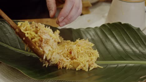 Laying-out-Biriyani-rice-onto-a-palm-tree-leave