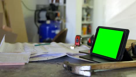 Digital-table-and-carpenter-tools-on-table-in-workshop-4k