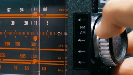 tuning analog radio dial frequency on scale of the vintage receiver