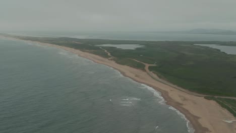 Drone-view-of-coastline-and-breaking-waves-on-Magdalen-Islands-in-Quebec