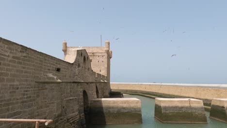 Wide-view-of-old-waterfront-fortification,-Sqala-du-Port-in-Essaouira