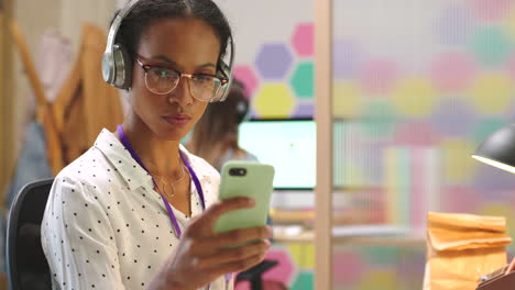 woman using smartphone in office