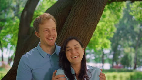 portrait of laughing couple on sunny park. happy pair smiling on camera closeup.