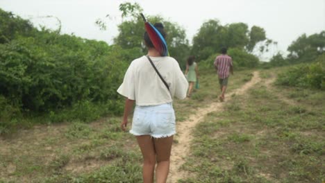 young woman walking green field meadows in india