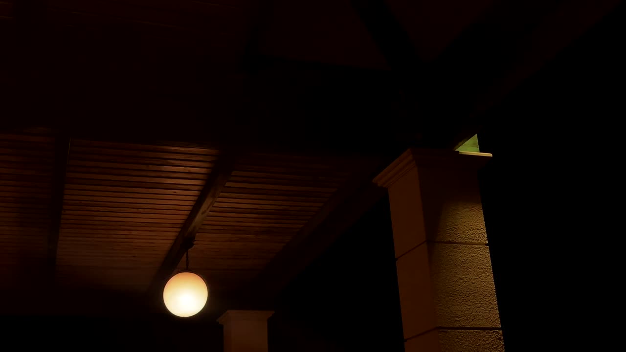 Soft glowing light under a wooden roof with a pillar at night in Greece