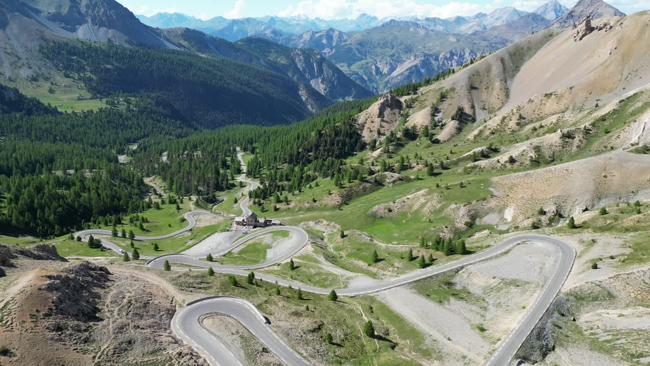 Scenic Road with Hairpin turns at Col Izoard Mountain Pass in French Alps, France - Aerial 4k