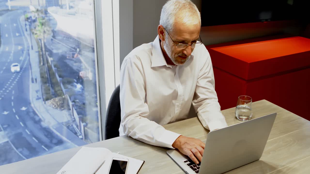 Businessman using laptop in hotel room 4k