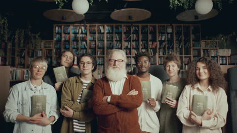 group portrait of author and fans with books at signing event in library