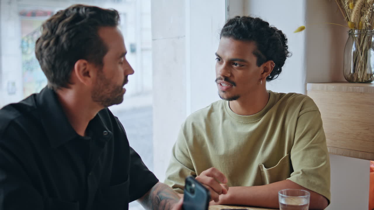 Two partners talking bar enjoying friendly communication close up. Male speaking