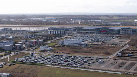 aerial flight towards airport of gdansk with many parking cars on parking area