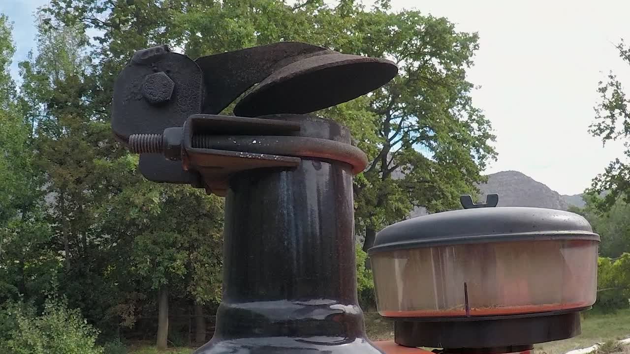Close up machinery detail: Diesel exhaust pipe vibrates rain cap