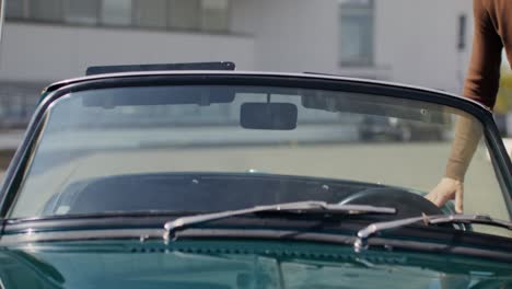 couple enjoying a drive in a vintage convertible