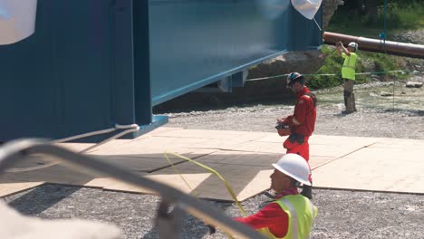 workers rigging a bridge structure on a sunny day at a construction site in tende, south of france