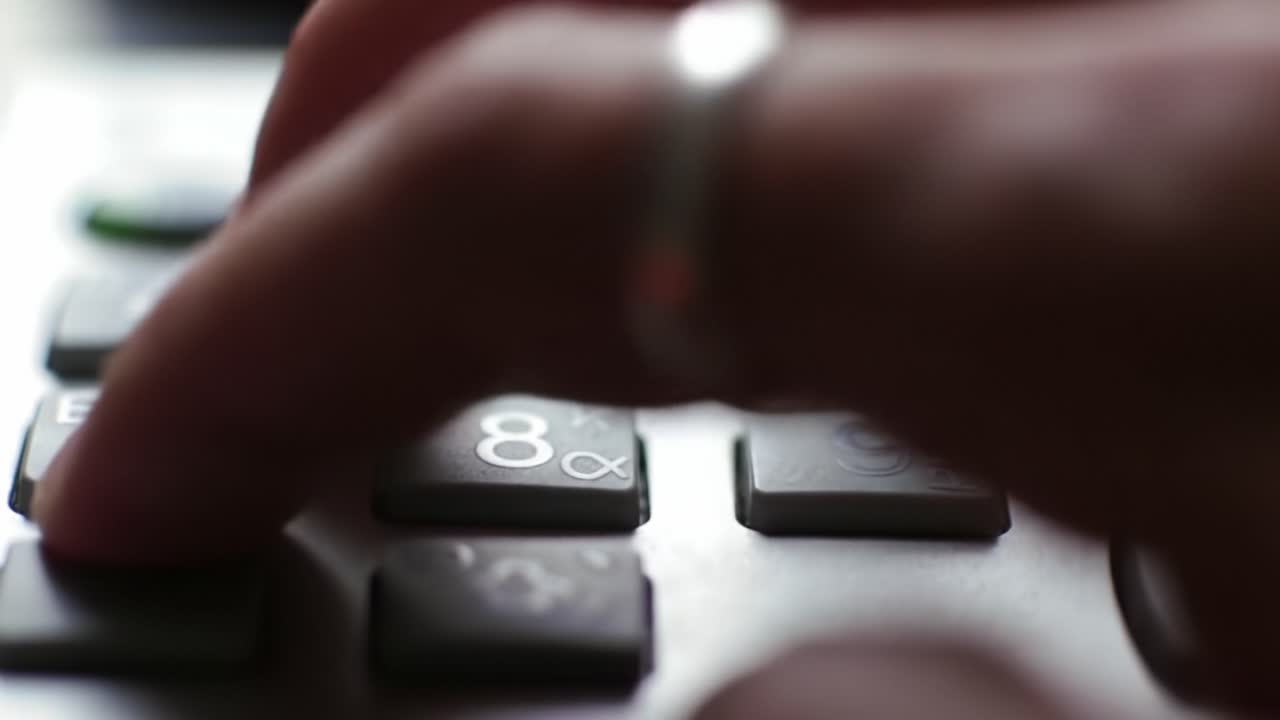A Close-Up View of a Finger Pressing Keys on a Calculator, Highlighting the Precision and Utility of Modern Calculation Tools in Everyday Life