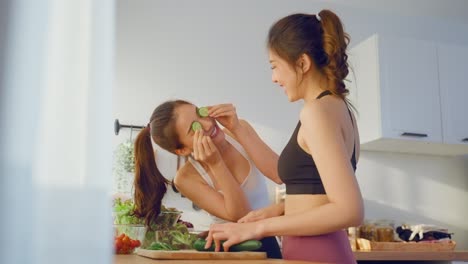 two women cooking healthy salad together