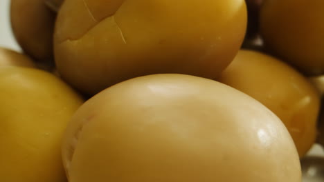 pickled round green olives from greece as background, top view. high quality 4k footage